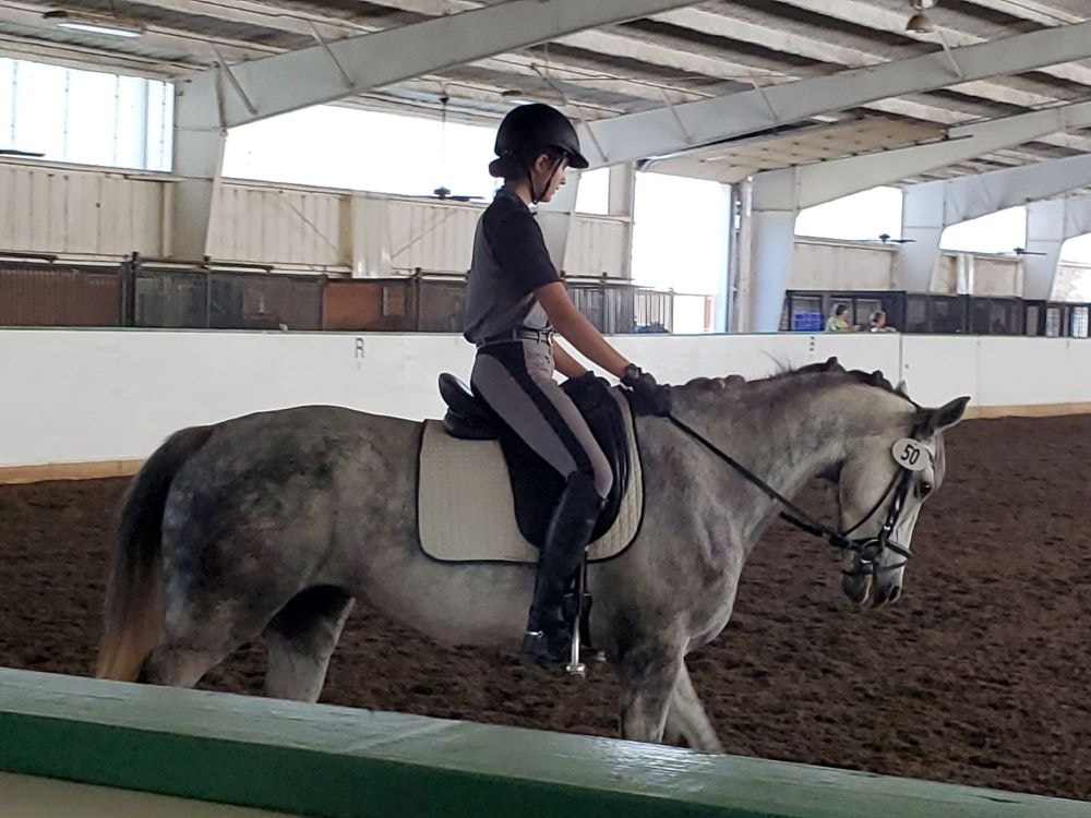 Chloe riding Barbie Doll