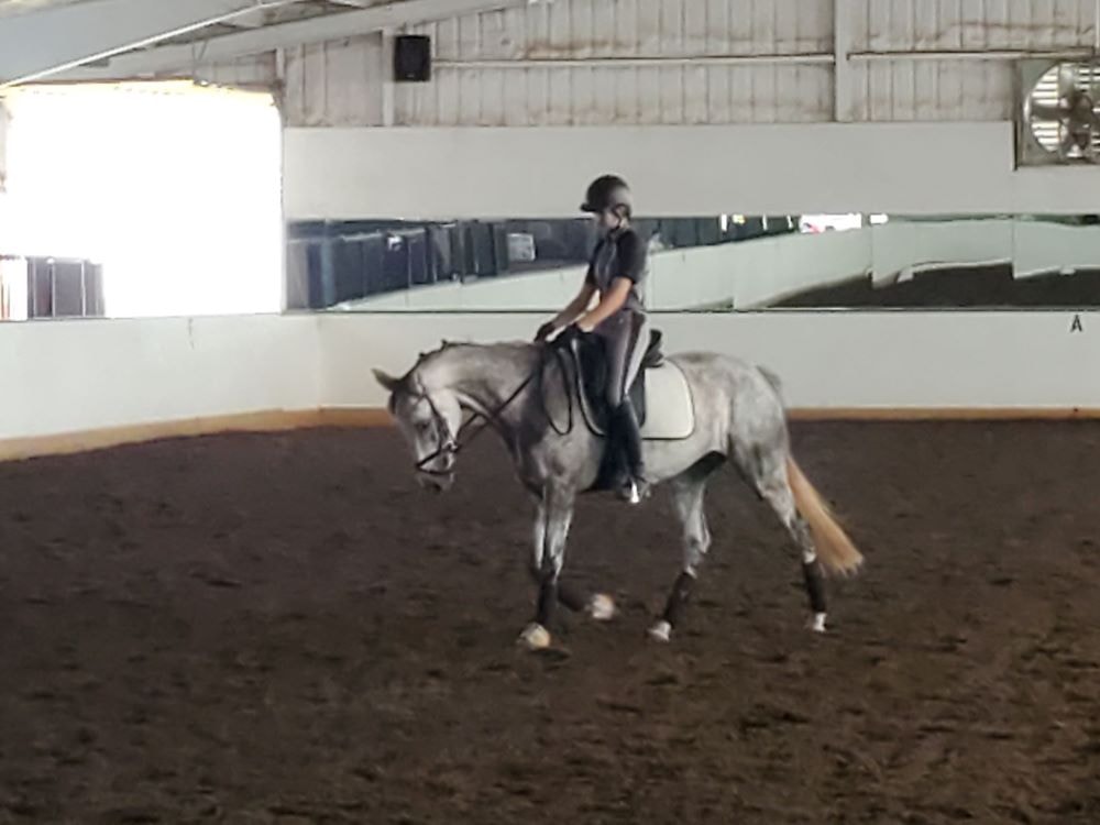 Chloe riding Barbie Doll